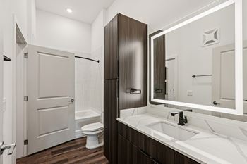A bathroom with a white sink and a white toilet